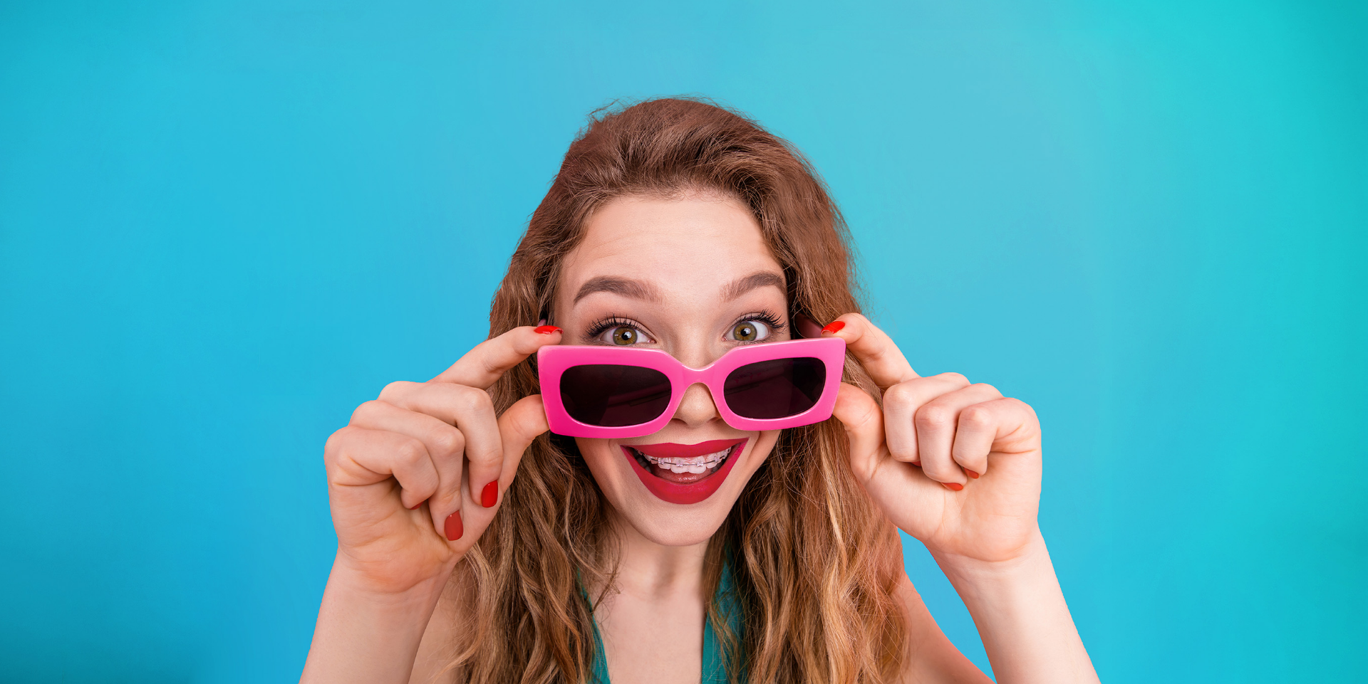 girl with braces and pink sunglasses